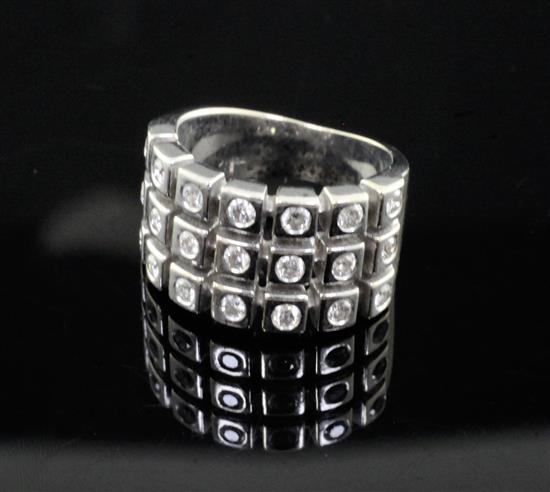 An 18ct white gold and three row diamond dress ring, size L.